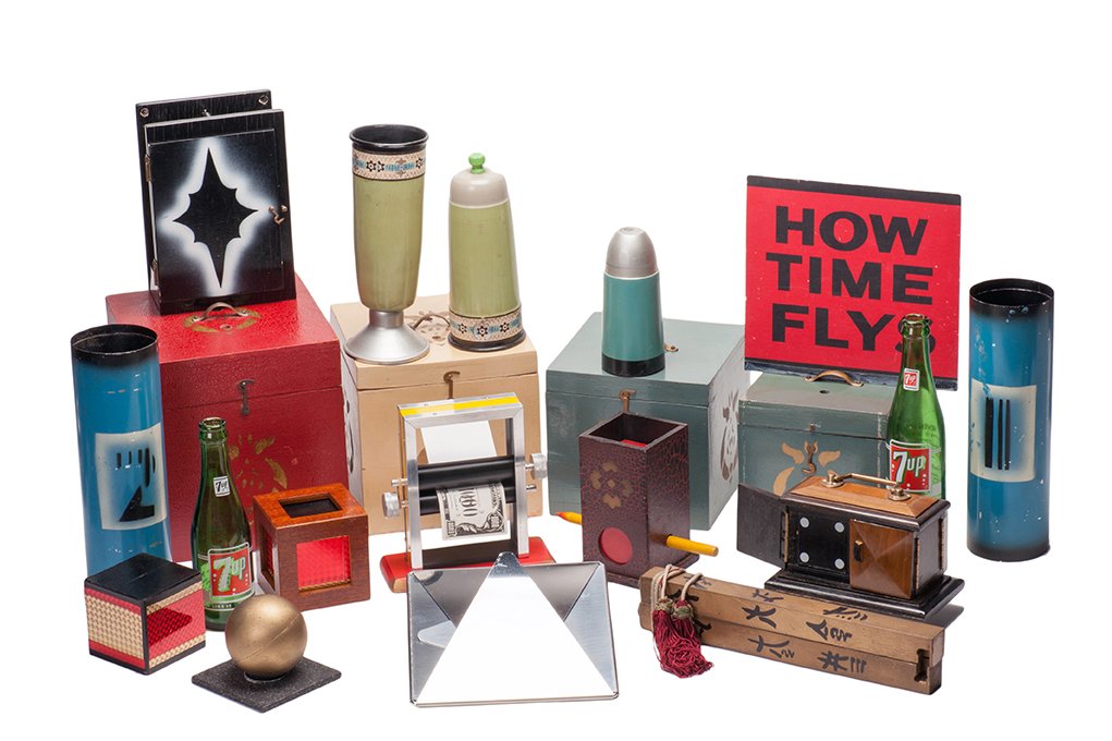 Group of 14 miscellaneous vintage magic tricks.: [Miscellaneous] Group of 14 miscellaneous vintage magic tricks. Including Disintegrator Box (Supreme), How Time Flys (Grant), Vampire Block (Abbott), Block off Cord (American; 3 ¾” walnut block), N