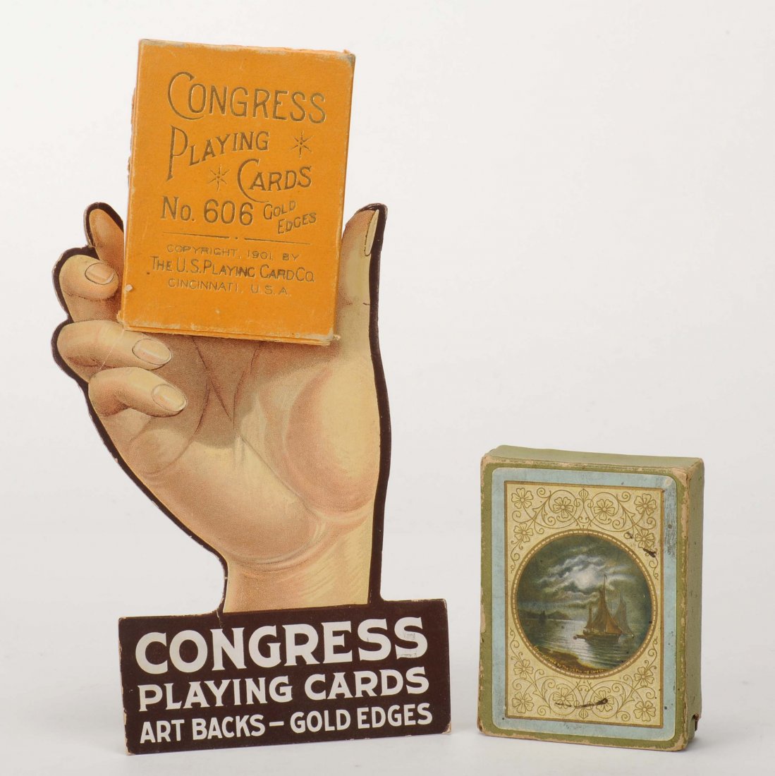 Three Congress Playing Card items. Including one: Three Congress Playing Card items. Including one Congress Cardboard Display Stand for Deck of Playing Cards with easel back, ca. 1910. 7x 4 ¼”; two decks of Congress 606 Playing Cards – “The Mi