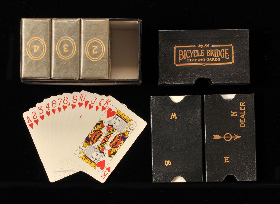 Bicycle Bridge No. 86, Four Boards and Four Packs for: Bicycle Bridge No. 86, Four Boards and Four Packs for Duplicate Bridge. USPC, ca. 1925. Boards #2-#4 are mint sealed in their original glassine wrappers and #1 is NM.