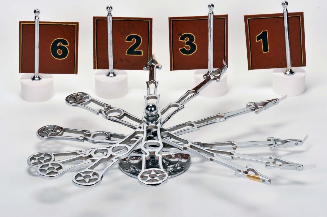 H.C. Evans Carnival Mexican Six Arrow Spindle. Chicago,: H.C. Evans Carnival Mexican Six Arrow Spindle. Chicago, ca. 1920. An elaboration of Chuck-a-Luck using 12 numbers instead of three dice, all metal parts are heavily nickel plated. With 12 pins and car