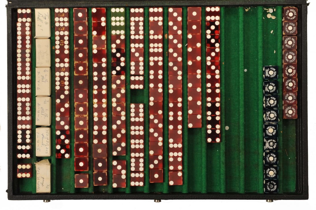 Collection of crooked dice. Primarily plain “tops”: Collection of crooked dice. Primarily plain “tops” (mis-spotted dice), some stamped with the logo of now-defunct Las Vegas casinos, and several sets still wrapped as delivered from the manufacture