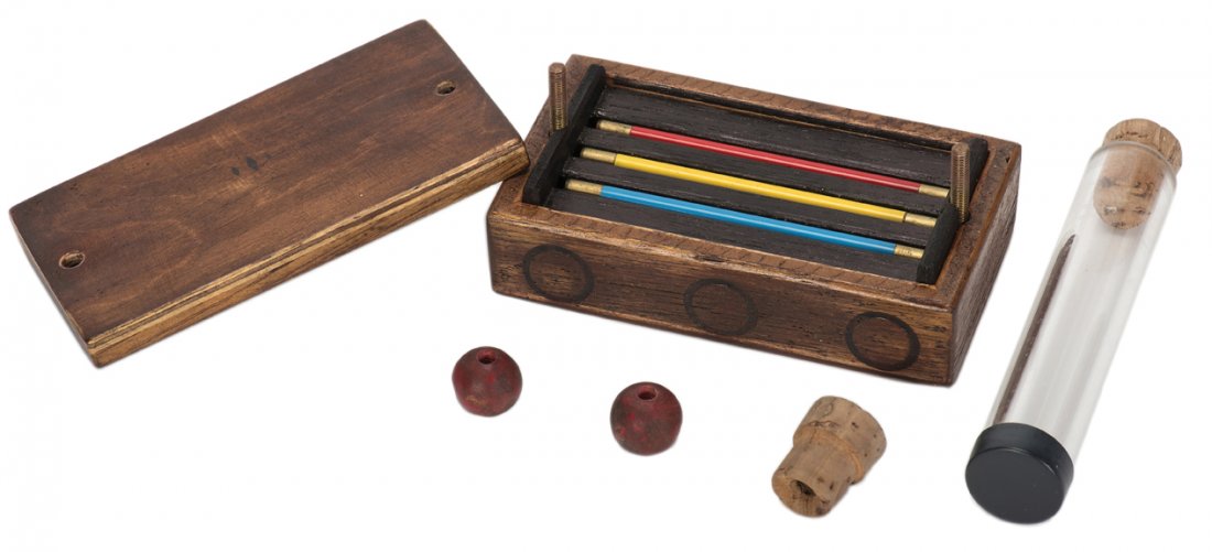 Miniature Wand Trick. German, ca. 1985 [?].: Miniature Wand Trick. German, ca. 1985 [?]. Any or all of three small metal wands vanish from a small wooden chest and reappear in a cork-closed test tube covered by a cloth. Mechanical box cleverly d