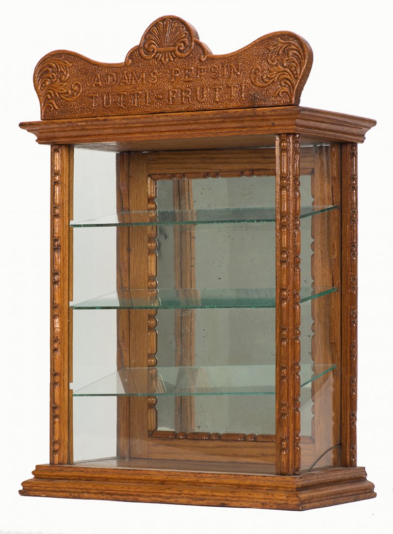 554. Adams’ Pepsin Tutti Frutti Wood and Glass Gum Case: 554. Adams’ Pepsin Tutti Frutti Wood and Glass Gum Case With Three Glass Shelves. 18” tall. With a crack on bottom of left side panel, otherwise excellent.
