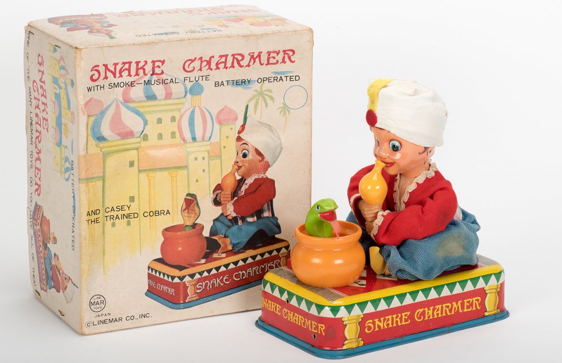 939. Snake Charmer With Smoke-Musical Flute Toy. Japan,: 939. Snake Charmer With Smoke-Musical Flute Toy. Japan, Linemar, ca. 1960. Battery operated toy. Lithographed tin and fabric with plastic pieces. With original box (showing wear). Very good. Working.