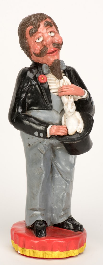 Statue of Magician Producing Rabbit From a Hat.: Statue of Magician Producing Rabbit From a Hat. [Niagara Falls]: Rob Allen, 1980s. 12” tall. Initialed and numbered by the artist at the base. Minor paint wear; very good.