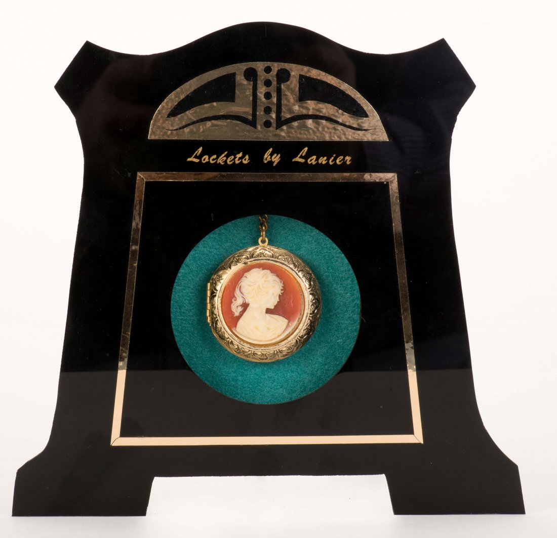 Mental Locket. Indiana, PA: Kline, 1970s. A previously: Mental Locket. Indiana, PA: Kline, 1970s. A previously empty golden locket seen through the opening of a black Lucite stand (7" tall) is found to hold the miniature version of a selected card. One of 