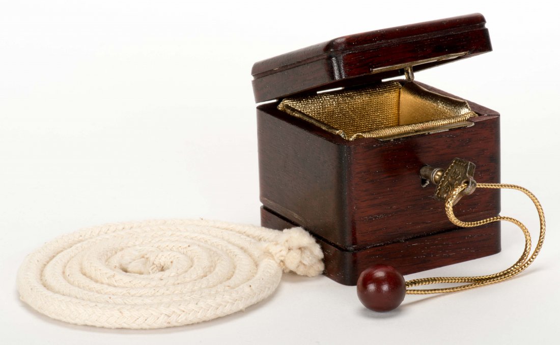 Ring-A-Ling. Indiana, PA: Kline, 1980s. A borrowed ring: Ring-A-Ling. Indiana, PA: Kline, 1980s. A borrowed ring vanishes from the rope on which it's threaded and reappears in the locked wooden box. Box approx. 2 ½" cubed. With rope and silk, plus instruct