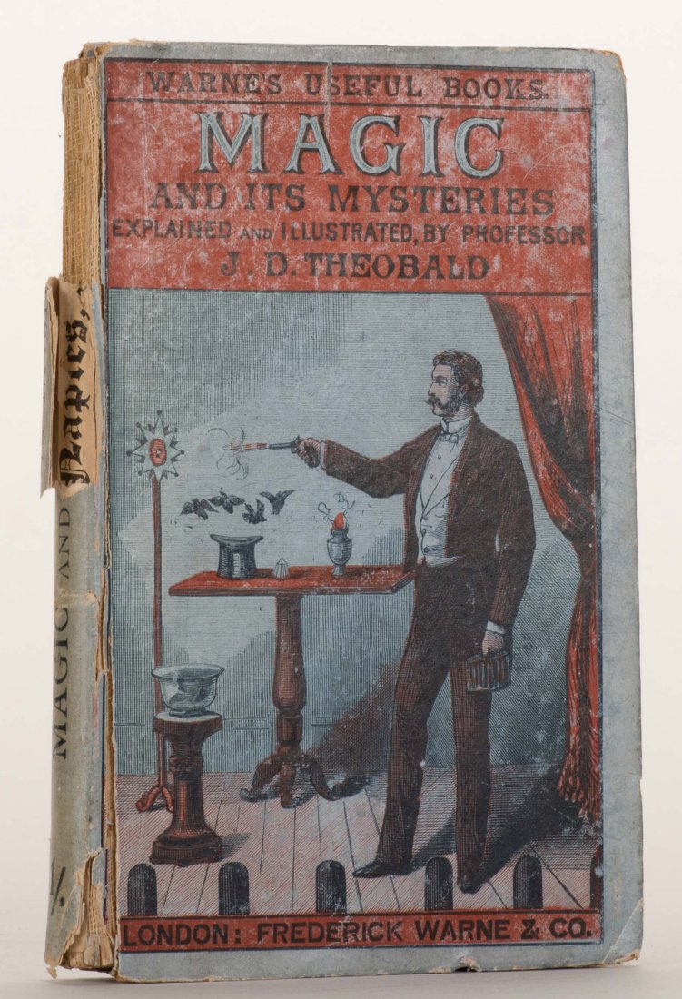 Theobald, J.D. Magic and Its Mysteries. London, (1880).: Theobald, J.D. Magic and Its Mysteries. London, (1880). Publisher's colored pictorial boards, illustrated. 16mo. Upper third of spine torn off, another portion peeling, internally good.