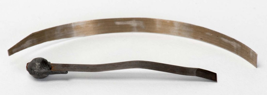 Houdini Lock Pick and Shim. Two pieces of spring steel,: Houdini Lock Pick and Shim. Two pieces of spring steel, one with soldered-on metal knob, the other honed to a slight point. Owned and used by Houdini for picking locks. The larger 3” long. With a LO