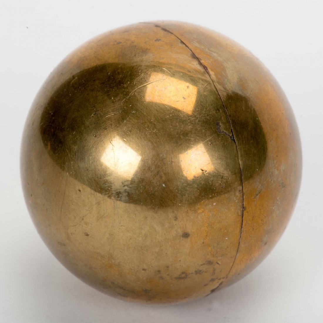 Red Hot Ball. London: Gamages, ca. 1940s. Precision: Red Hot Ball. London: Gamages, ca. 1940s. Precision made brass ball (2” diam.) unscrewing at the center, revealing an inner tube so designed that a mixture of lime powder and acid will cause the bal