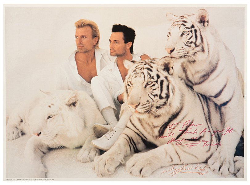 [Siegfried & Roy]. Siegfried & Roy and White Tigers.: [Siegfried & Roy]. Siegfried & Roy and White Tigers. Komar: West Germany, 1986. Horizontal poster depicts the Las Vegas magic duo dressed in white, together with three white tigers. 28 3/4 x 20 3/4".