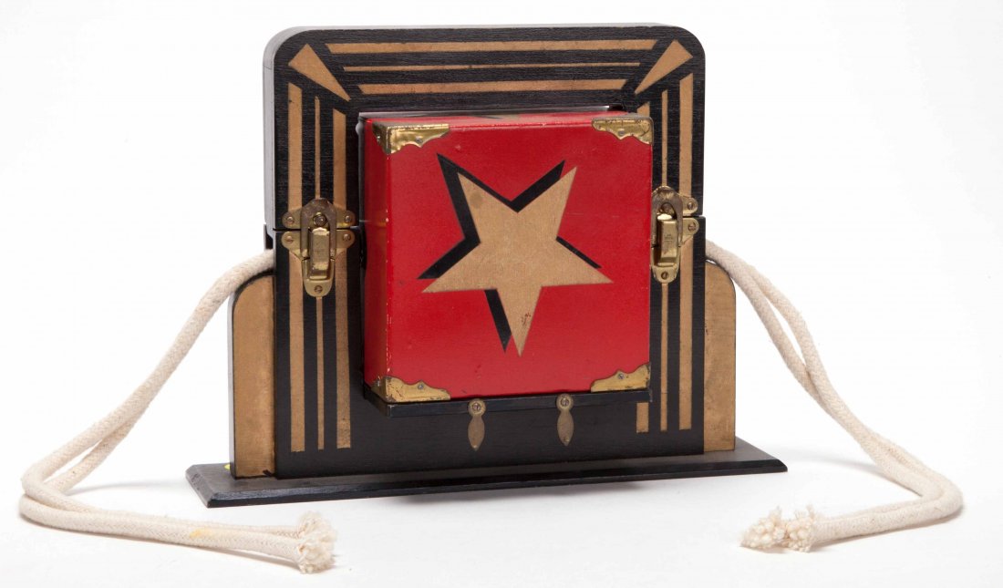 Cuban (Cube-On) Release. Colon: Abbotts Magic Mfg.,: Cuban (Cube-On) Release. Colon: Abbotts Magic Mfg., ca. 1965. A sturdy block is tied to a wooden frame by two ropes running through holes in the block and frame. With a tug, the block penetrates the r