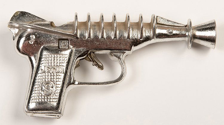 Jet Jr. Space Police Cap Gun. Cromwell, Conn.: J&E: Jet Jr. Space Police Cap Gun. Cromwell, Conn.: J&E Stevens Co., ca. 1950s. New Jr. Space Police Fully Automatic Repeater Cap Gun, with a shiny chrome finish. 6 _ long. Very light wear on toy, on chip