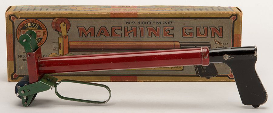 No. 100 Mac Machine Gun. Pittsburgh: McDowell: No. 100 Mac Machine Gun. Pittsburgh: McDowell Manufacturing. Red long-barreled paper buster toy gun with green paper roll holder and black handle. Includes box with colorful illustrations. 13 _ long.