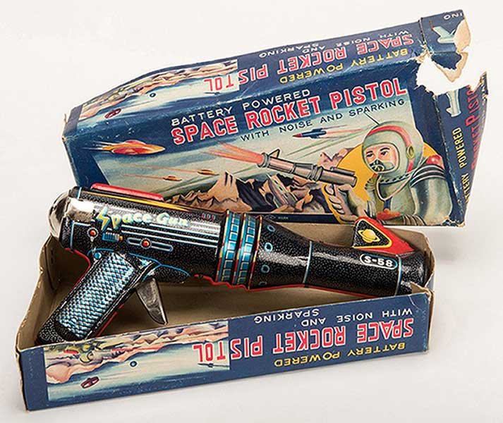 Space Rocket Pistol. Japan: T. Nomura, mid-twentieth: Space Rocket Pistol. Japan: T. Nomura, mid-twentieth century. Tin litho toy gun with vibrant colors, makes a firing sound when operated and end lights up. Includes original box. 10 long. Very light sc