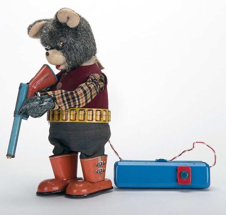 Shooting Bear. Japan: SAN, mid-twentieth century. Tin: Shooting Bear. Japan: SAN, mid-twentieth century. Tin litho bear toy, battery operated by controller, when operating the bear walks, eyes light up, and he raises and lowers the gun. 10 tall. Boots scu