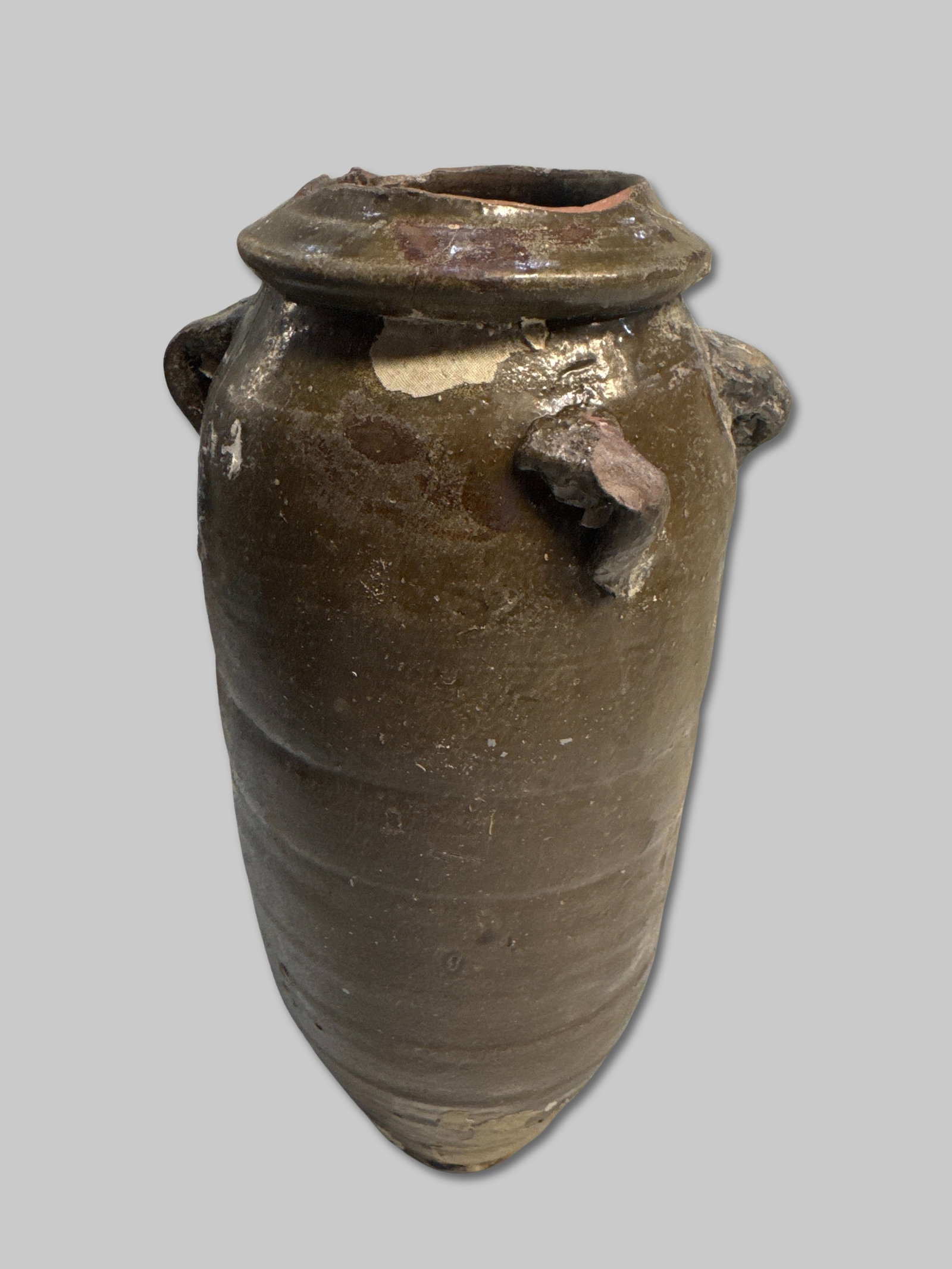 Glazed Stoneware Jar with Organic Overlay and Marine Encrustation 3.875" x 11": Tall, slender stoneware jar originally fitted with four lug handles—one now missing. The surface is richly textured with barnacle clusters, marine concretions, and mineral accretions. The rim displa
