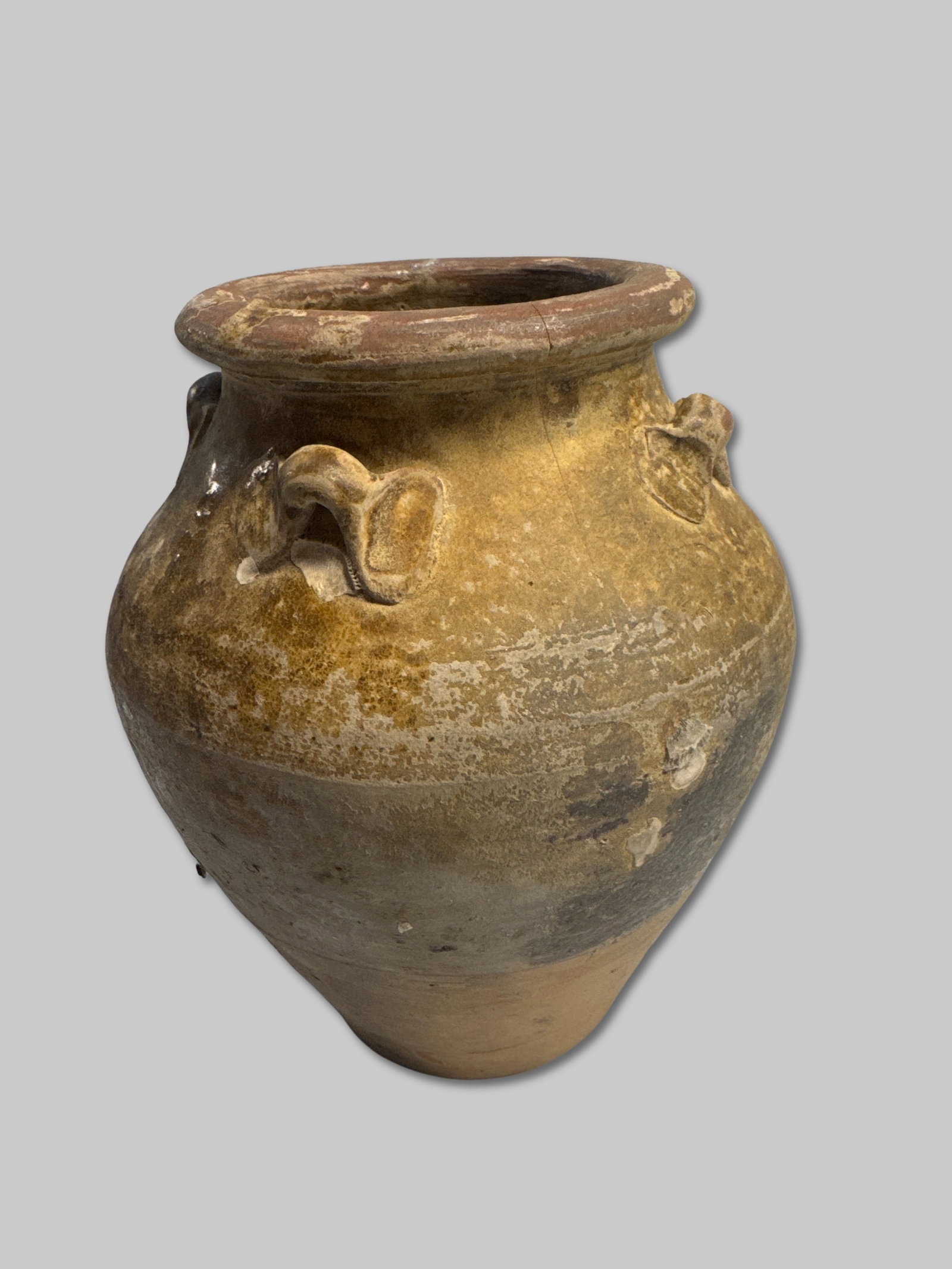 Short, Two-Toned Stoneware Jar with Four Lugs and Internal Encrustation 5" x 6.5": A short, rounded-shoulder stoneware jar with four intact lug handles and striking color variation—dark upper half transitions into a warm ochre lower body. Surface encrustation is minimal. The inter