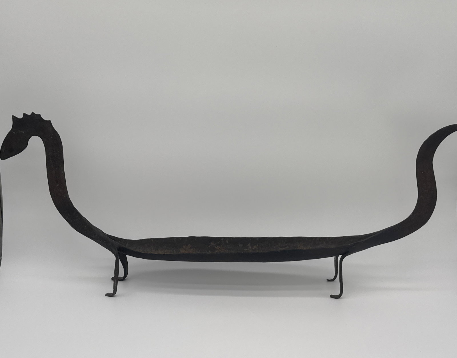 Iron Sea Serpent Dish – Stylized Viking Longship Form 28.25" x 11" x 2.625": Large iron centerpiece tray or incense boat formed as a serpent-headed Viking ship. Four curled feet support the shallow hull while the serpent head and coiled tail rise upward in dramatic silhouette.