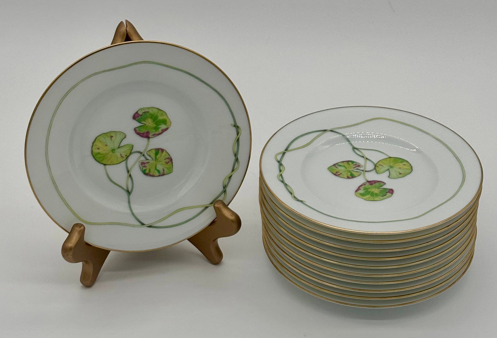 Set of Twelve Hermès NIL Waterlilly Porcelain Bread and Butter or Dessert Plates- 6.5”: "A delightful set of twelve Hermès NIL Waterlilly porcelain bread and butter or dessert plates, each measuring 6 1/2 inches in diameter. These small-format plates feature vivid botanical decoration w