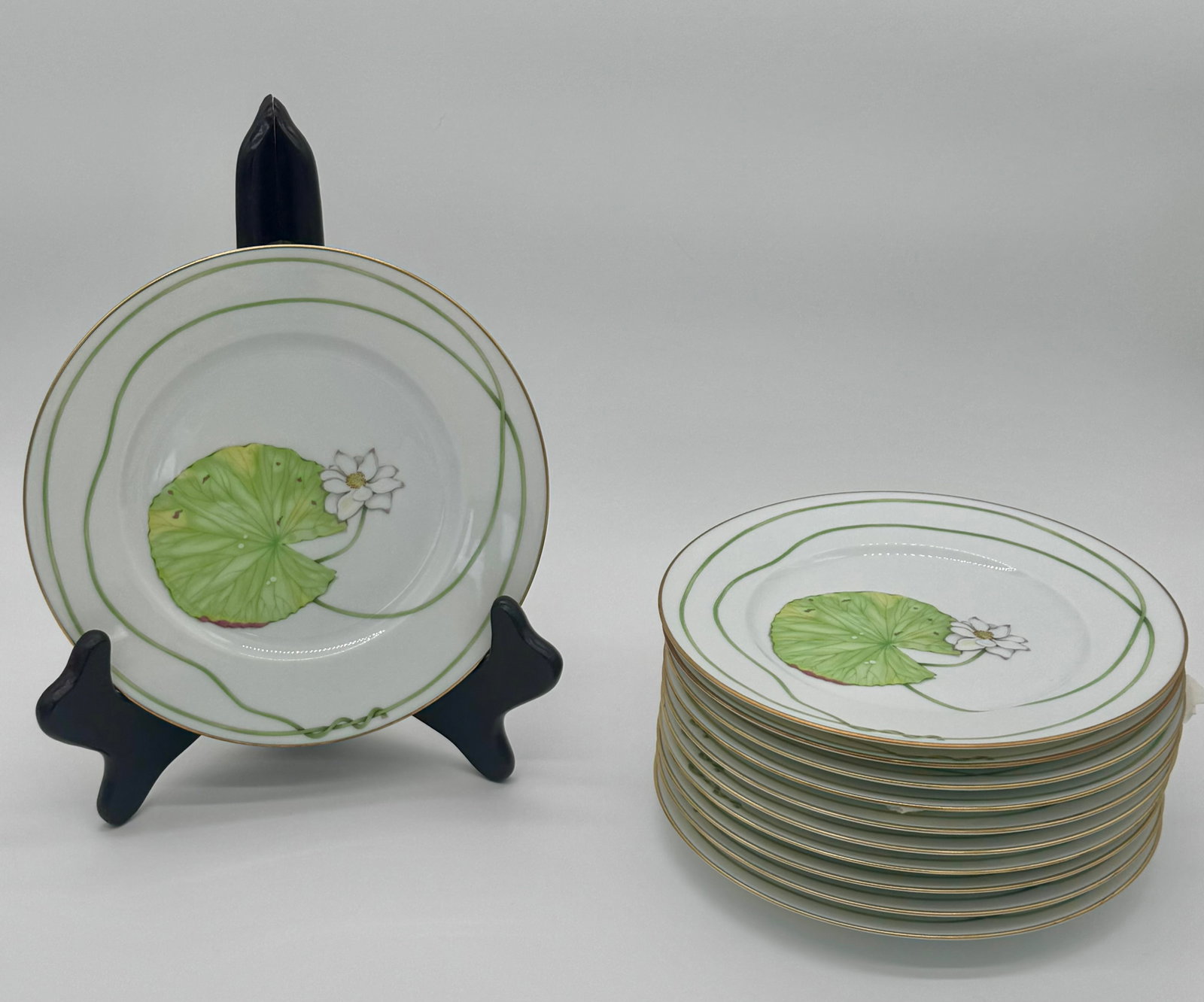 Set of Twelve Hermès NIL Porcelain Waterlilly Side or Salad Plates-8 7/8 in.X 7/8 in.: "A matching set of twelve Hermès NIL porcelain plates, each measuring 8 7/8 in. in diameter and approximately 7/8 in. high, suitable for salad, side, or dessert use. Decorated with a finely painted f