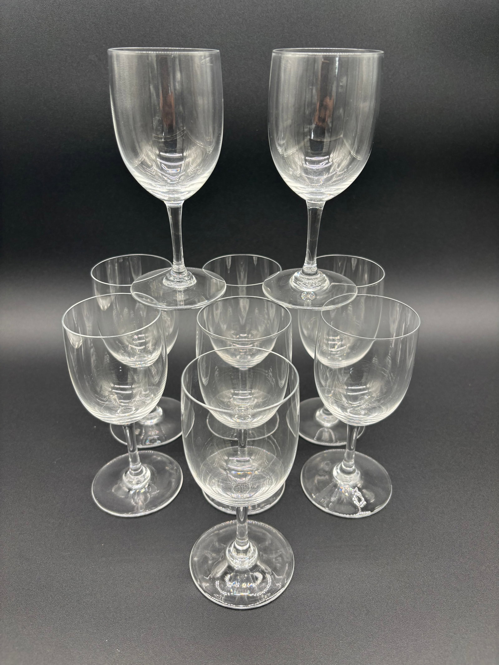Baccarat Crystal Light Bodied Red Wine Glasses - Lot of 9 (Medium Height) C.1970's: Type: Baccarat Crystal Glasses Quantity: Lot of 9 Dimensions: Length: 6" Width: 2.5" Depth: 3.5" Origin: France Wines of a darker red colored nature are best enjoyed within glasses of this size
