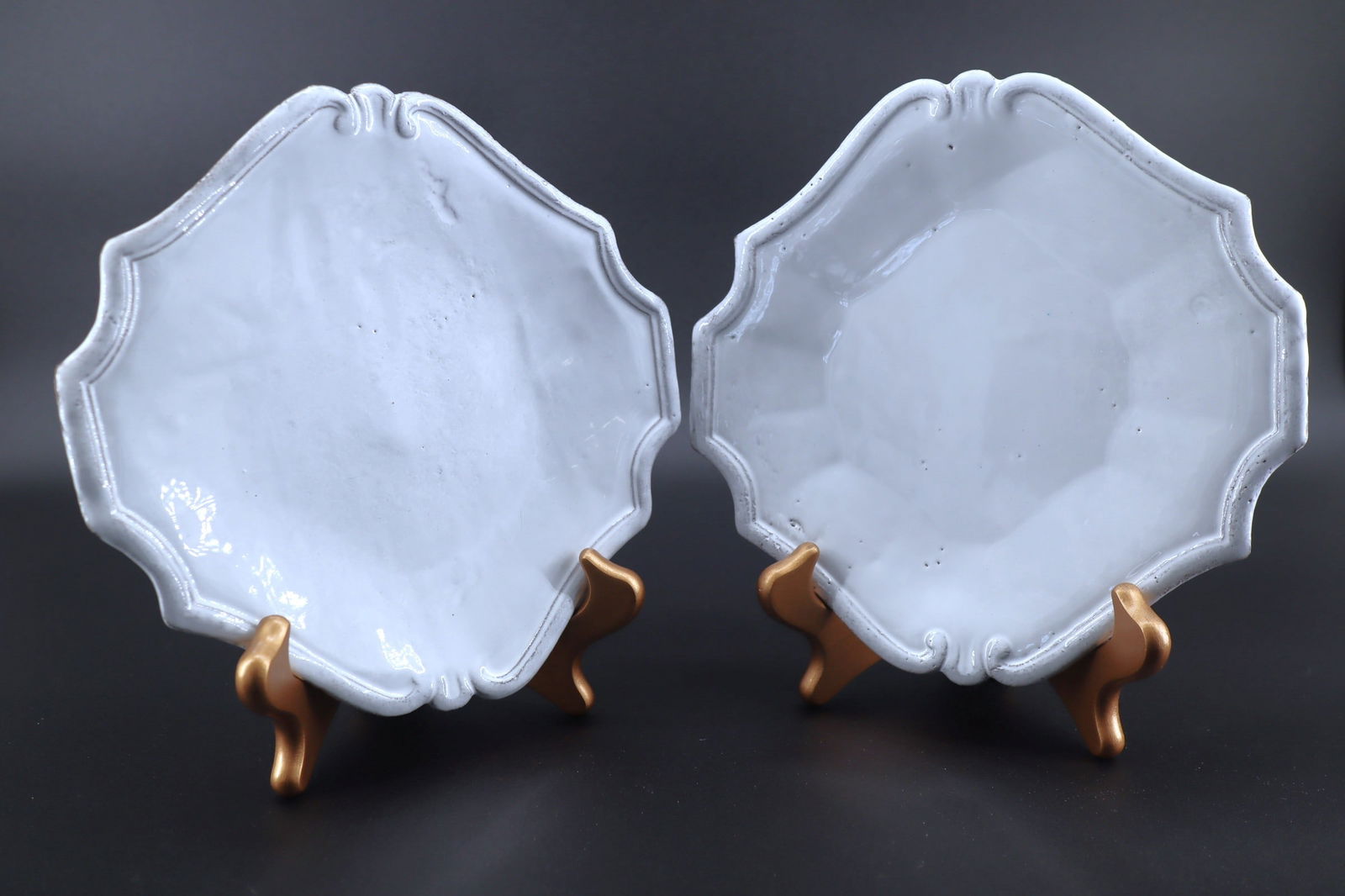 White Glazed Octagonal Bone China Plates with Molded Rococo Borders, Set of Ten: Artist/Maker: Unknown Fine white glazed ceramic (possibly bone china or porcelain) with a molded scalloped and scrollwork edge in Rococo revival style. Each plate exhibits an octagonal outline softene