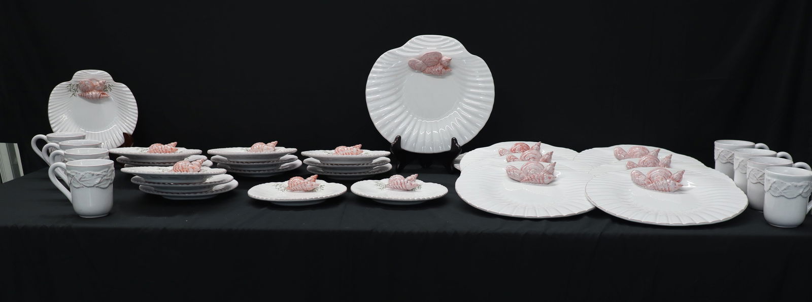 Hand-Painted Pink Shell Sea Clam Relief Plates & Cups Set - 34 Pieces, Molde Portugal: Artist/Maker: Unknown Glazed ceramic earthenware, white body with molded relief pattern and applied hand-painted pink clam shell designs. Big plates and small plates feature a molded scallop-rim desig