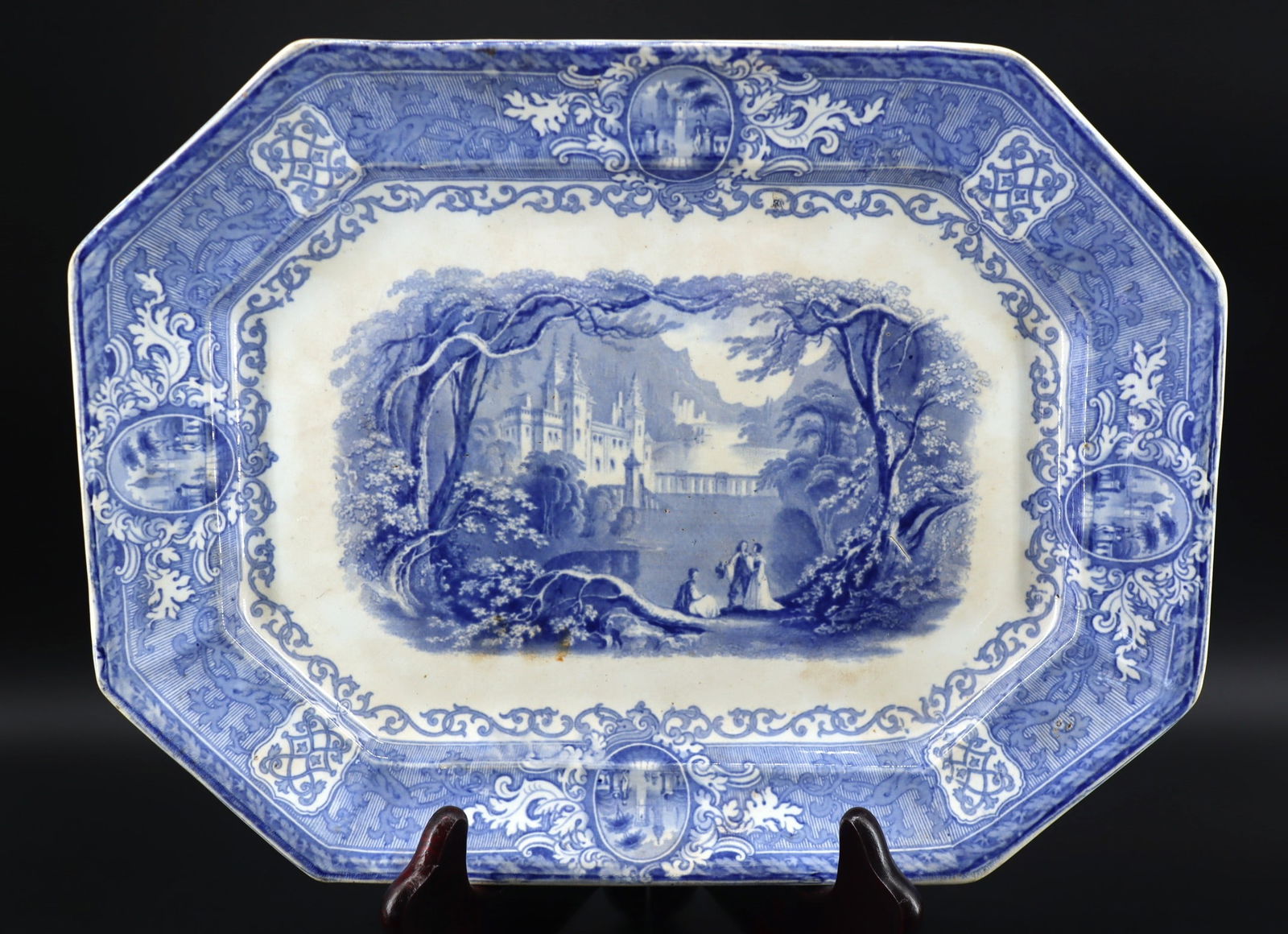 Staffordshire Blue Transferware Platter, 'Panama' Pattern, E. Challinor & Co, C.1854–1862: Artist/Maker: E?Challinor & Co Underglaze cobalt?blue transfer?printed refined white earthenware, panels with Romantic castle central motif surrounded by ornate vignettes and scrolled borders, 10?side