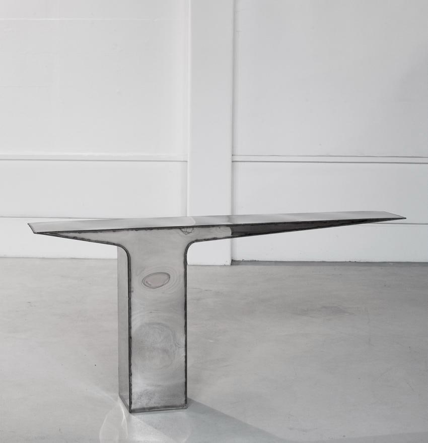 Pol Quadens (b. 1960) Blade Weldings Console Polished stainless steel, exposed welds Limited: Pol Quadens (b. 1960)Blade Weldings Console Polished stainless steel, exposed welds Limited edition of 8 pieces Signed H95 W200 D30 cm Self-taught, Pol Quadens single-handedly embodies the uniqueness