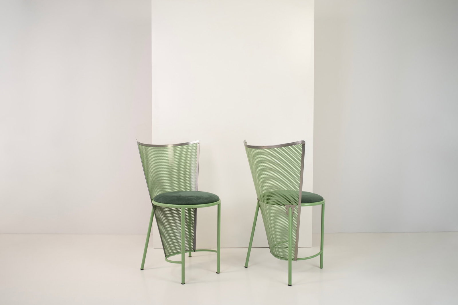 Frans Van Praet (born in 1940) Sevilla Pair of chairs Green-lacquered tubular metal frame; backrest: Frans Van Praet (born in 1940)SevillaPair of chairsGreen-lacquered tubular metal frame; backrest and rear panel in curved, perforated sheet metal. Circular seat padded and upholstered in green fabric.