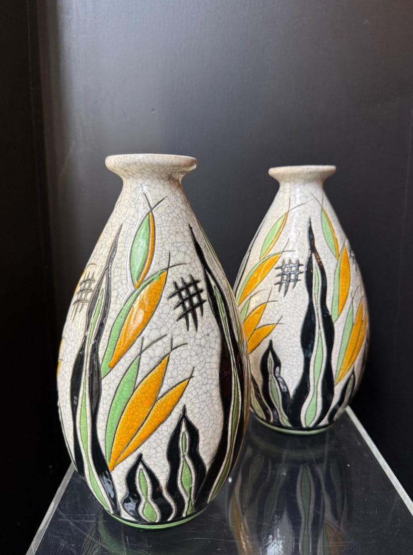 Charles Catteau Pair of ovoid vases Ceramic with glazed cactus decoration in yellow, green, and: Charles CatteauPair of ovoid vasesCeramic with glazed cactus decoration in yellow,green, and black on a crackled white backgroundStamp of the Boch factoryLa Louvière BrothersD1208H 32 cm