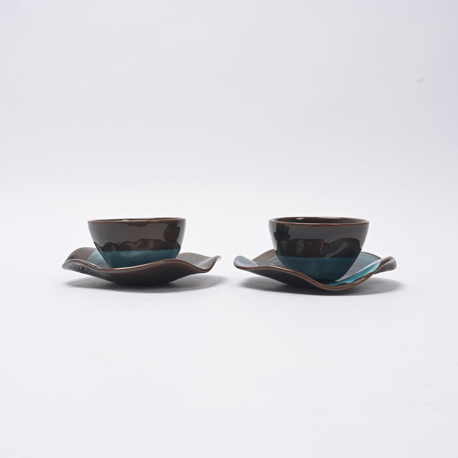 Claire de Lavallée (born in 1953) for Kenzo Apple Pair of cups and saucers Two-tone glazed: Claire de Lavallée (born in 1953) for Kenzo ApplePair of cups and saucers Two-tone glazed ceramic Kenzo edition Signed "Claire de Lavallée" and "Kenzo"2000Cups: 6.5 x 9.5 cm Saucers: 15 cmExcellent 