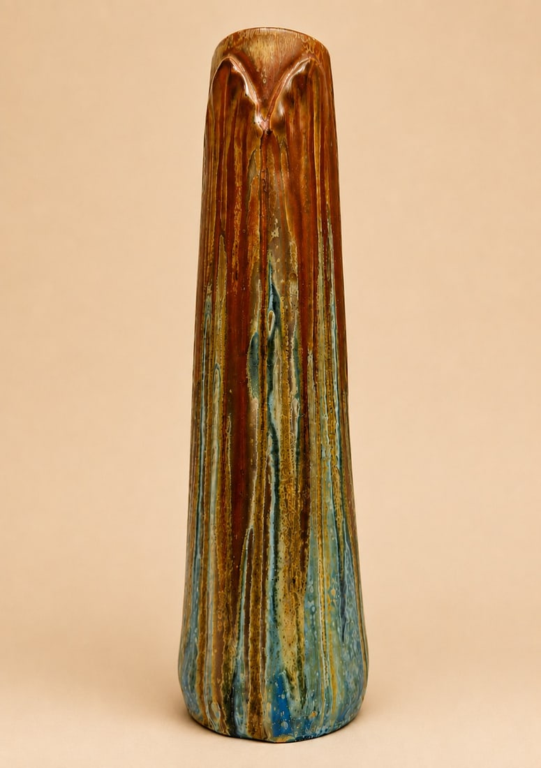 Gilbert Metenier (1976–1940) Tubular single-flower vase Glazed stoneware with a neck decorated: Gilbert Metenier (1976–1940)Tubular single-flower vaseGlazed stoneware with a neck decorated with palm leavesArtist’s signature engraved in relief.H 31 cm