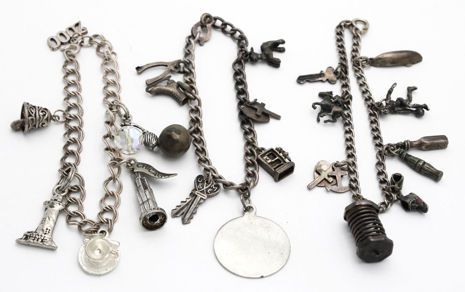 Sterling Charm Bracelets: Sterling Charm BraceletsThree Sterling Charms Bracelets with diameters of 2'', 2.25'' and 2.25''. They include a lovely set of charms such as a canoe, horse, wishbone and lighthouse.