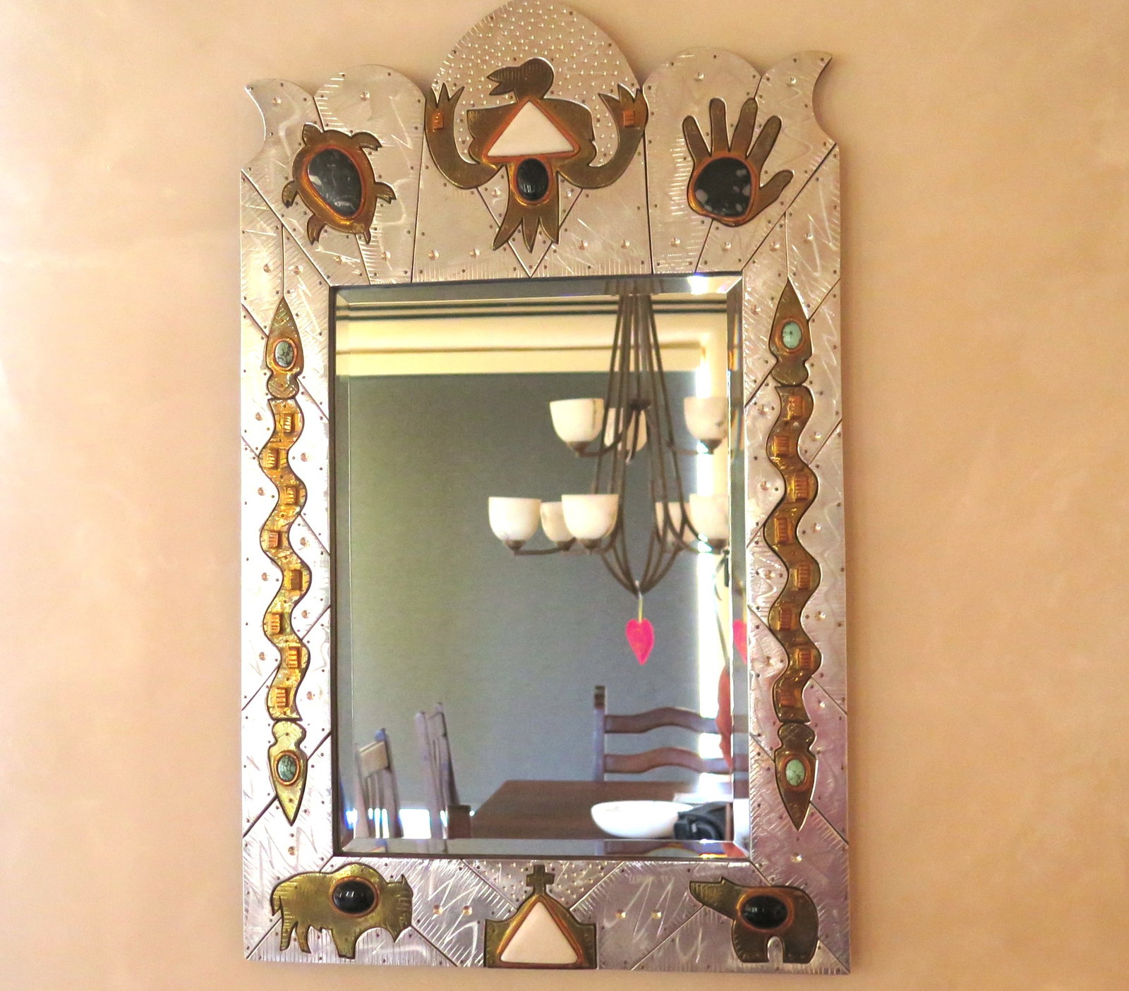 Thom Wheeler Southwest Mirror: Wheeler calls these large pieces "wall jewelry", which he constructs from high quality aircraft aluminum and a variety of other materials. Stylized copper thunderbird top center with alabaster triangu