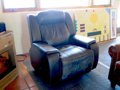 Brown Manual Leather Recliner: Manual lever on side with a wide leg support. Reclines and retracts easily.