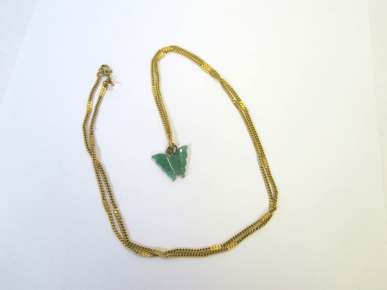 Monet Gold Tone Necklace with Carved Jade Butterfly: Marked Monet on the clasp, this lovely small butterfly is complemented by the gold toned necklace.Chain 28"