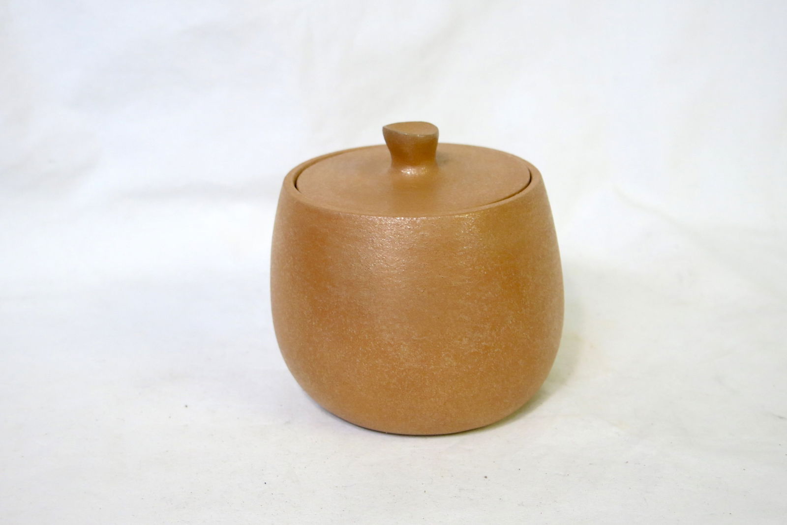 Eric Marcus Taos Pueblo Micaceous Sugar Bowl: Signed Eric Marcus on bottom. A golden micaceous sugar bowl to go with the creamer up next. The vessel is made from local clay that is naturally rich in mica, giving it a distinctive shimmer. The pot