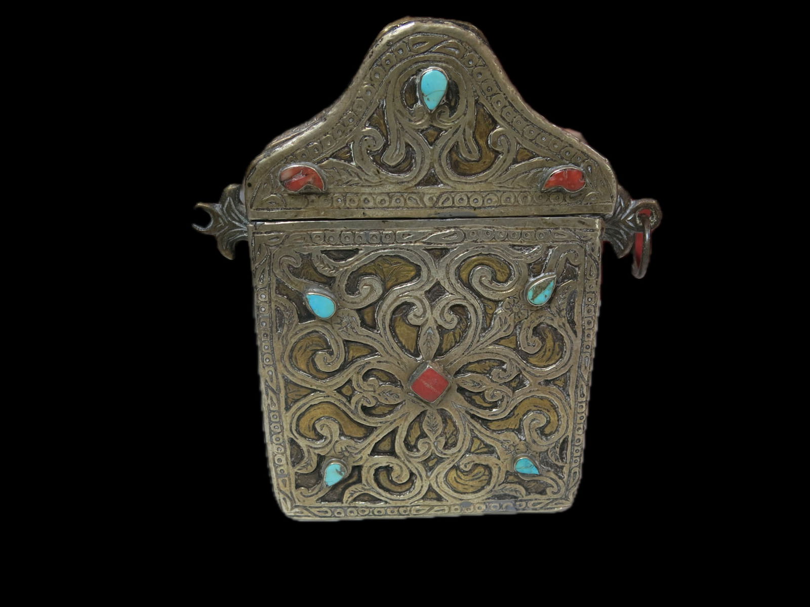 Tibetan Brass Turquoise and Coral Gau Box: Antique copper and coin silver repousse work in a classic gau shape with pitched top and lotus leaf motif. Coin silver box is punctuated by gilt leaves with diamond coral inset and turquoise teardrop
