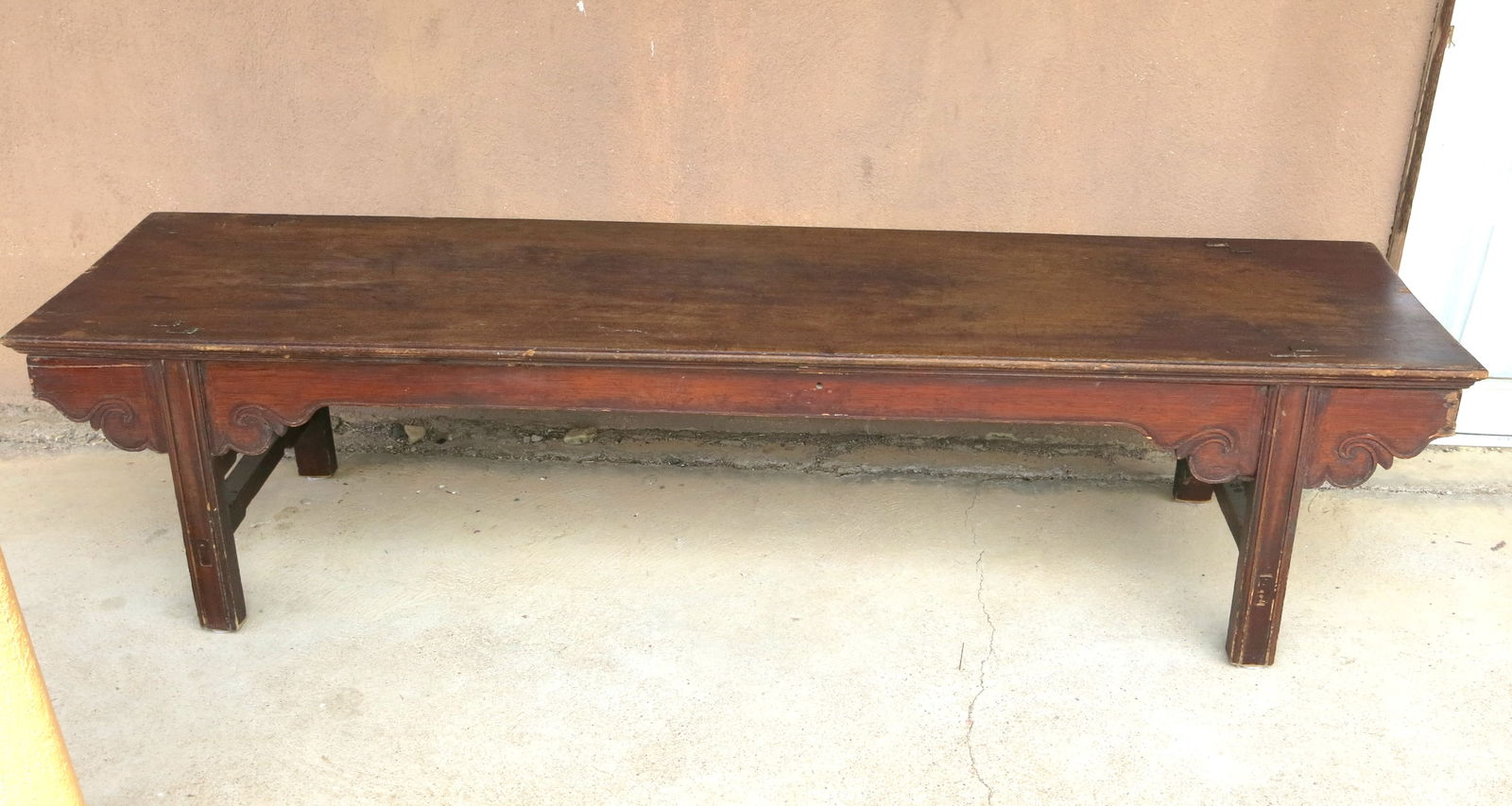 Rustic Low Chinese Antique Shrine Bench: Mortise and tenon construction on a well used surface. Great patina and classic The bench features a long, rectangular top made from a single plank of wood. The most notable design elements are the in