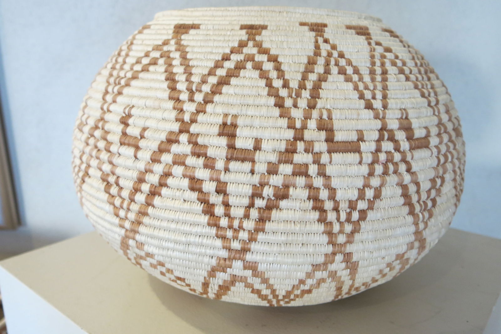 Seri Indian Brown/Cream Diamond and Donkey Basket: A Seri (Comcaac) Indian basket is a hand-coiled textile art form created by the indigenous Seri people of Sonora, Mexico. Once used for functional tasks like gathering desert fruits or carrying water,