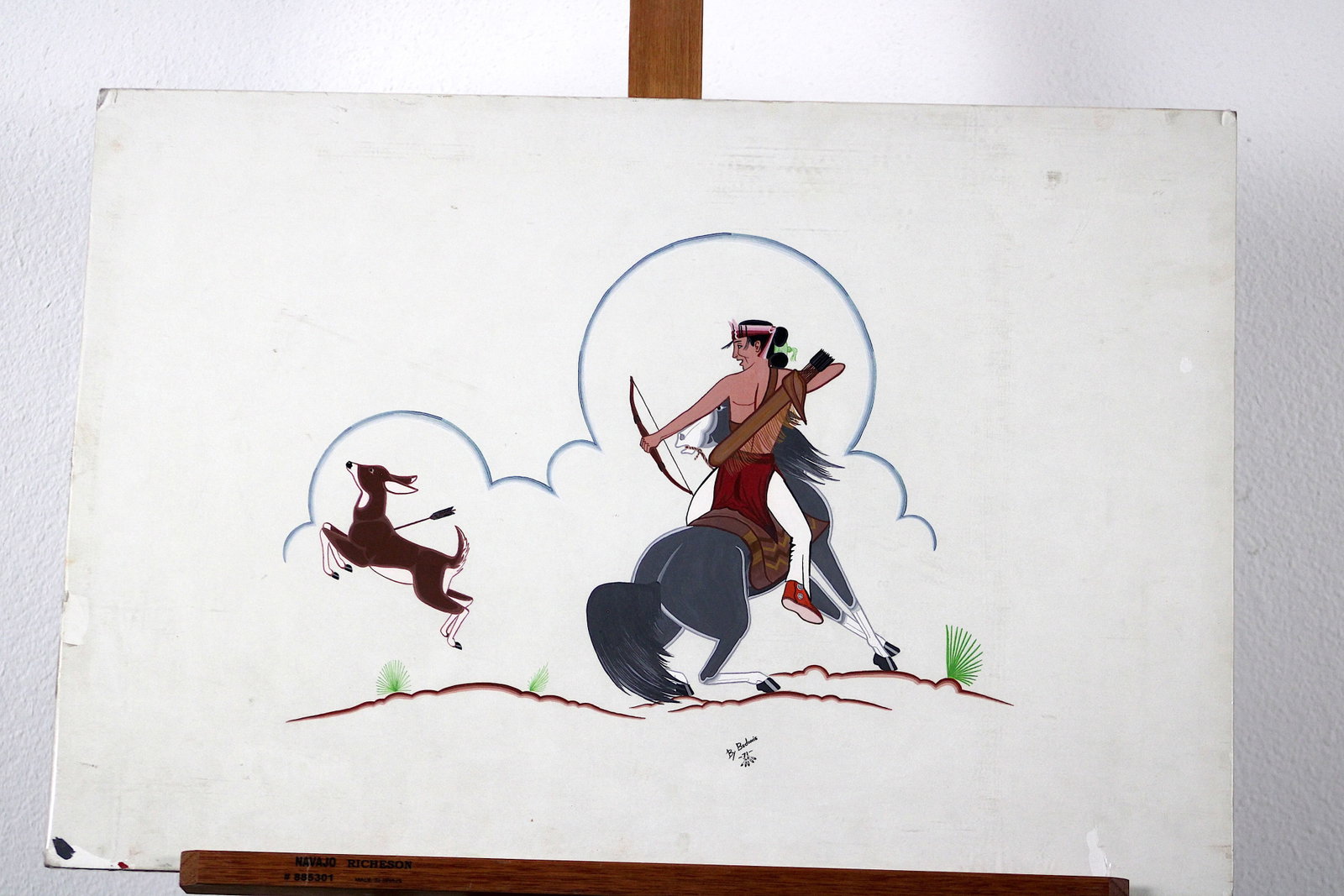 Bedonie Navajo Man Killing Deer Gouache 1971: Unframed. Original gouache/tempera painting on illustration board by a Navajo artist signed "Bedonie," depicting a mounted archer in traditional dress - bow drawn, feathered headdress, arrows in a qui