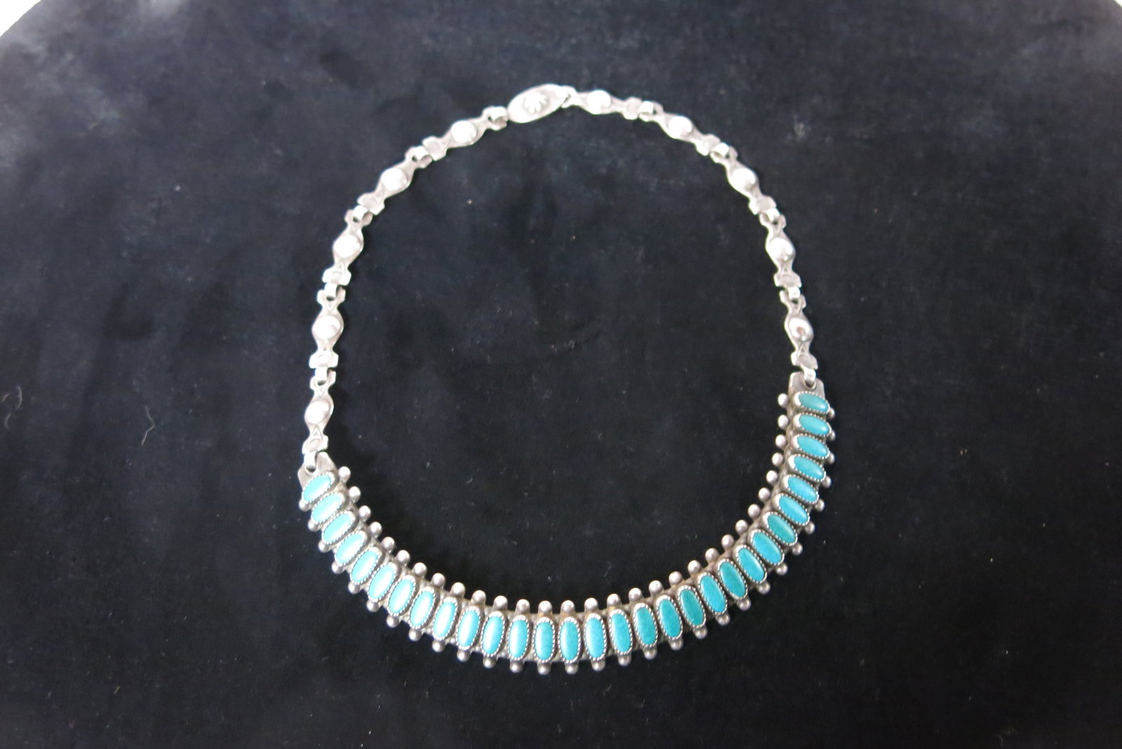Old Pawn Zuni Style Needlepoint Turquoise Choker: A fitted, semi-rigid sterling silver choker necklace, its front collar section formed by a dense row of over twenty needlepoint-cut oval turquoise cabochons - long, slender stones individually bezel-s
