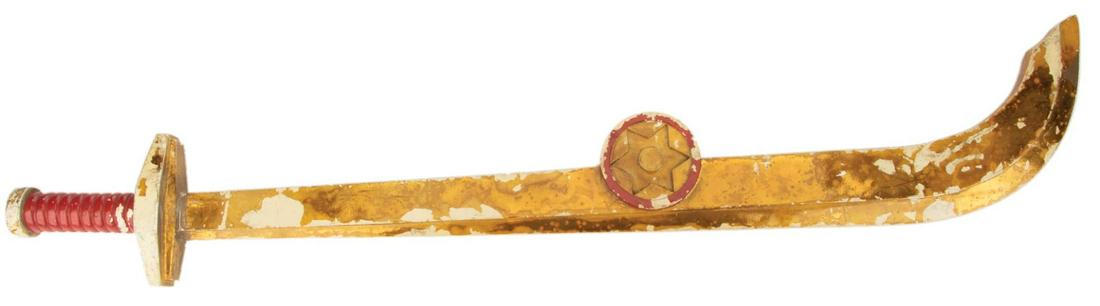 Sam J. Jones 'Flash Gordon' sword from Flash Gordon.: Sam J. Jones "Flash Gordon" sword from Flash Gordon. (Universal, 1980) Vintage original prop scimitar constructed of cast resin and expertly painted metallic gold and lacquered red, with curved "blade