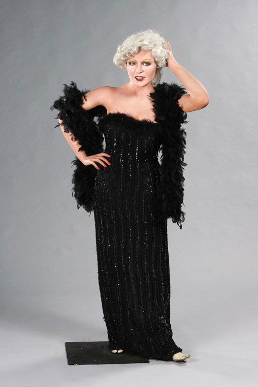 Mae West wax figure: 5. Mae West. Mae West looks sultry wearing a black floor length gown, black heels, and black feather boa as if