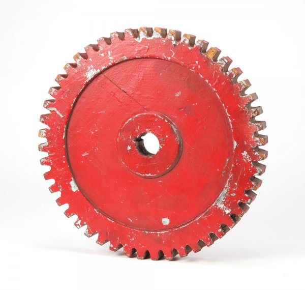 Original wooden machine gear from Modern Times: 786. Original wooden machine gear from Modern Times. (UA, 1936) Wooden machine gear painted red over original silver paint that shows through in numerous areas of the piece. Originally obtained throug