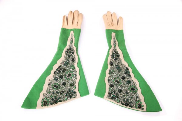 Emerald City Prime Minister jeweled gloves Wizard of Oz: 803. Emerald City Prime Minister jeweled gloves from The Wizard of Oz. (MGM, 1939) Adrian-designed cotton gloves with bright green felt attached gauntlets which feature an ornate design of faux emeral