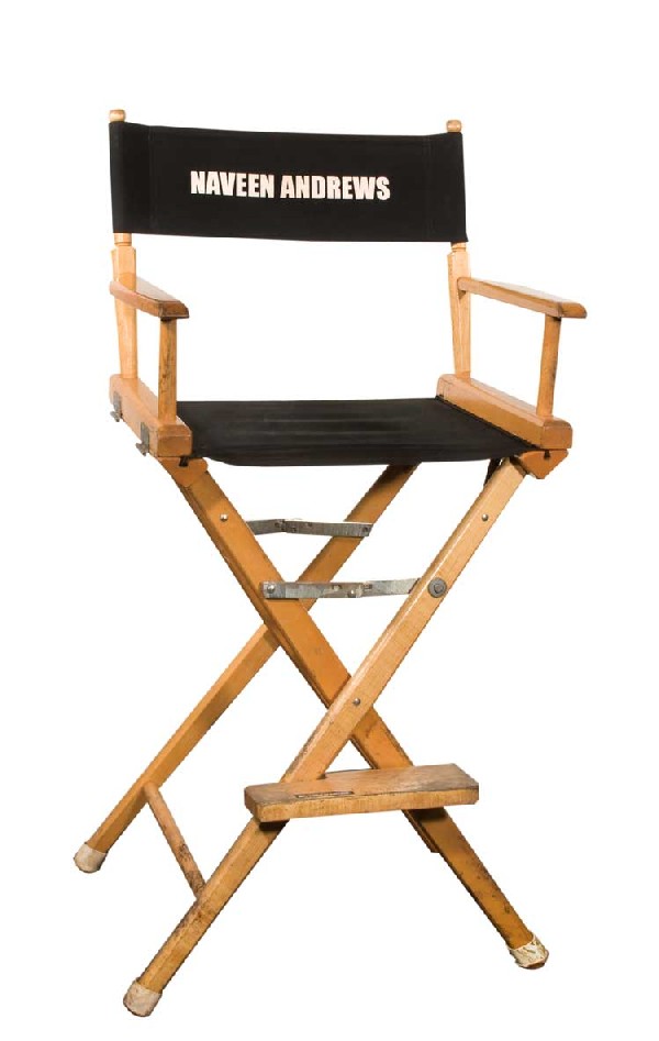 Set chair for Naveen Andrews "Sayid": Set chair for Naveen Andrews "Sayid." Wooden director's chair for Naveen Andrews "Sayid." Measures approx. 18 in. wide x 46 in. tall.