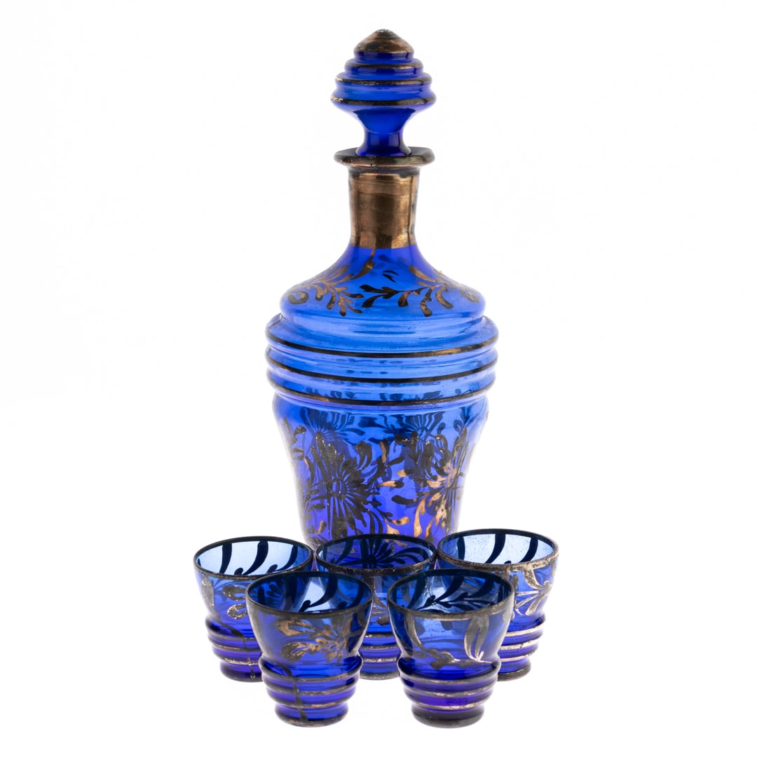 BOHEMIAN BLUE TINTED GLASS LIQUOR DECANTER WITH GLASSES: From a collection of Wedgwood and other selected ceramic/porcelain objects. Kindly examine all photographs provided in this listing or ask for a condition report. All items offered are in generally go